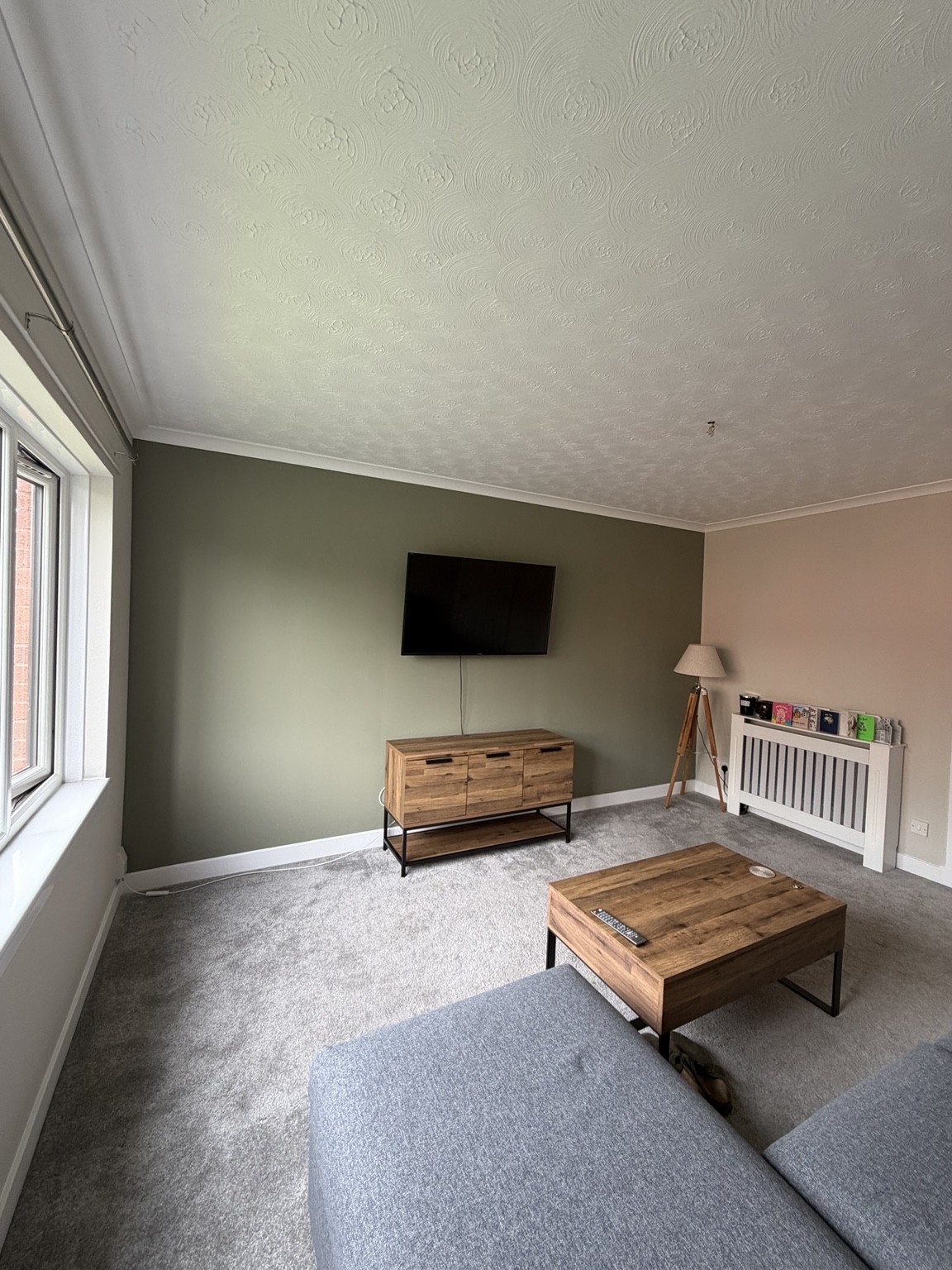 Living room decorated by DJM Decor with a green feature wall