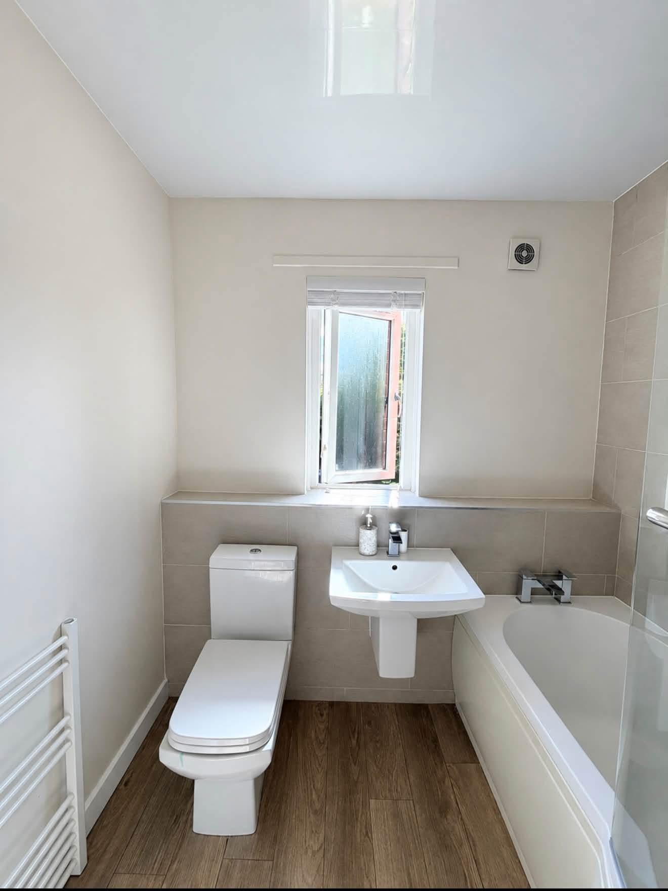 Bathroom decorated by DJM Decor with light painted walls, a white ceiling and window trim